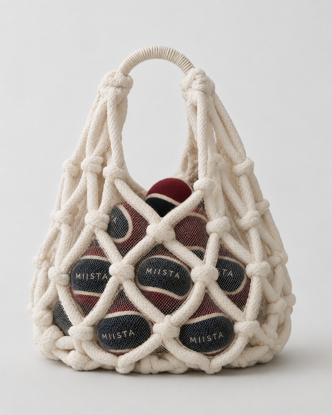 Woven net bag filled with MIISTA tennis balls