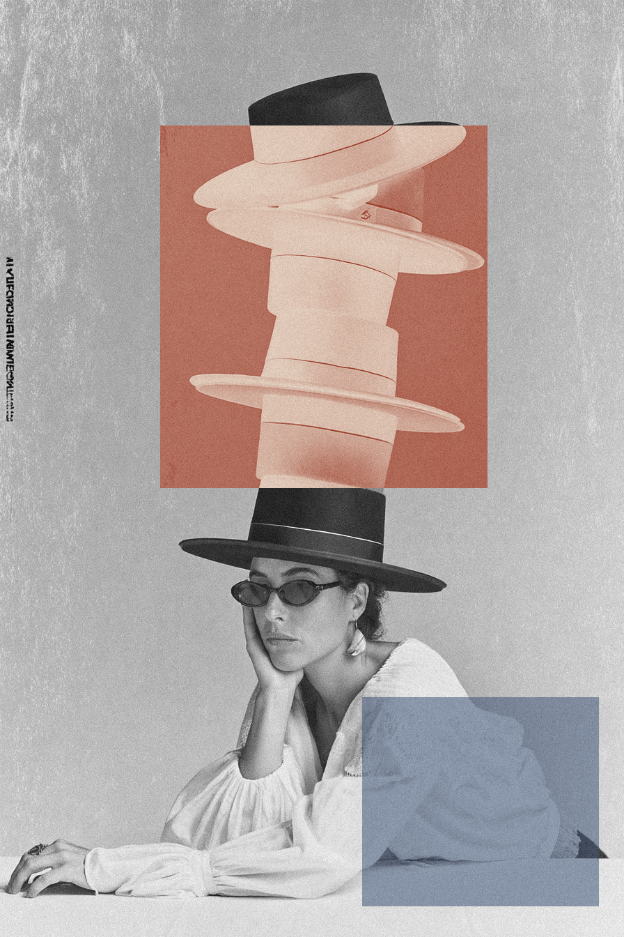 Portrait of the art director in a stack of black hats